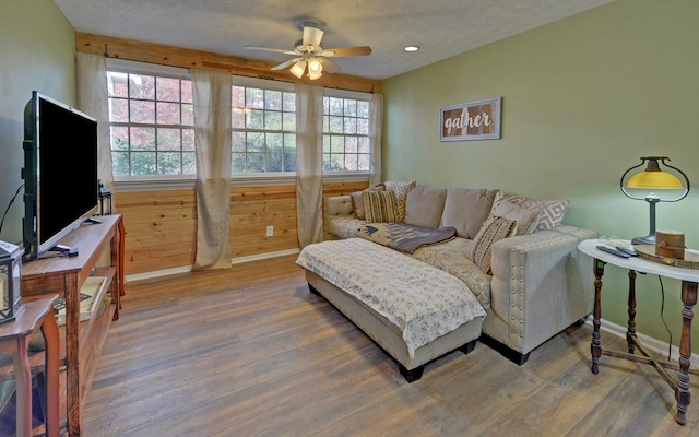 living room featuring plenty of natural light, hardwood / wood-style floors, and a textured ceiling