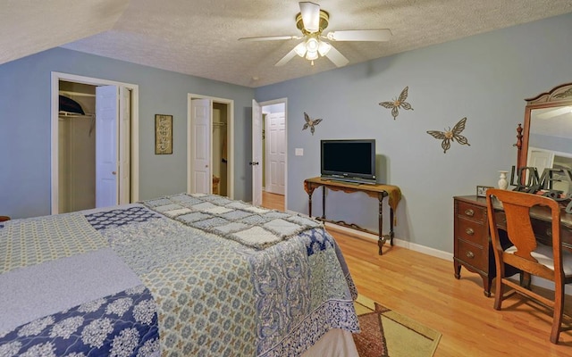 bedroom with hardwood / wood-style flooring, ceiling fan, and a textured ceiling