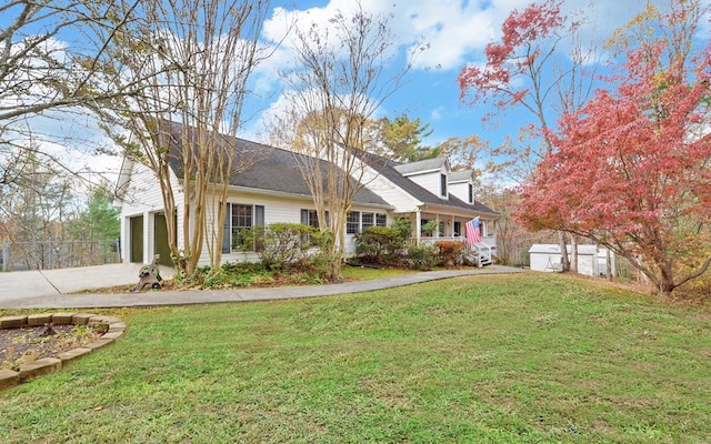 view of front of home featuring a garage, covered porch, and a front lawn