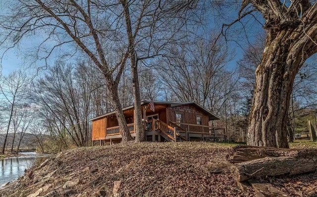 back of property featuring a water view