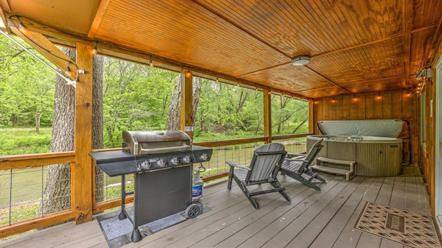 sunroom featuring wood ceiling and a healthy amount of sunlight