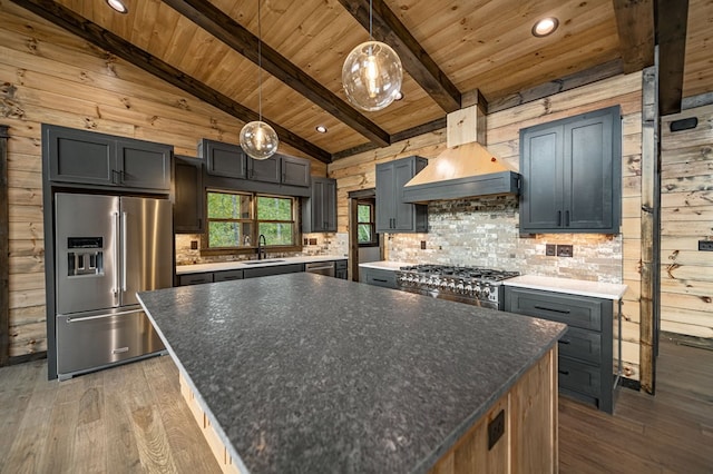 kitchen featuring hanging light fixtures, dark hardwood / wood-style floors, custom range hood, stainless steel appliances, and beam ceiling