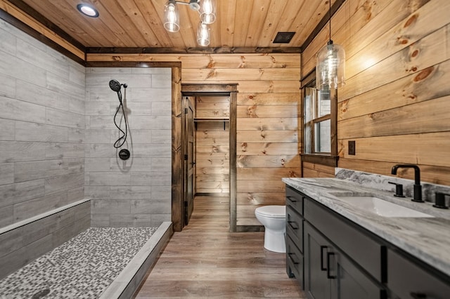 bathroom with wood walls, wood-type flooring, a shower, wood ceiling, and toilet