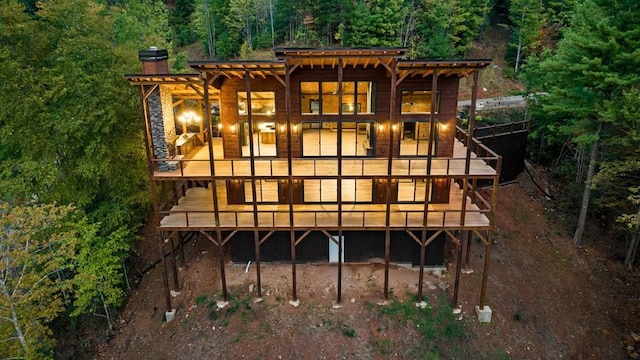 rear view of property featuring a deck