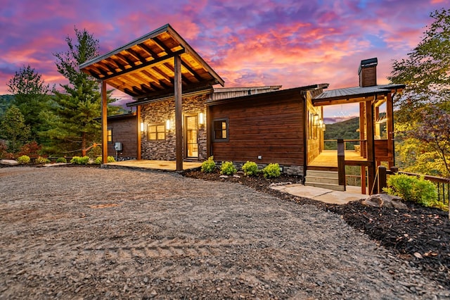 view of back house at dusk