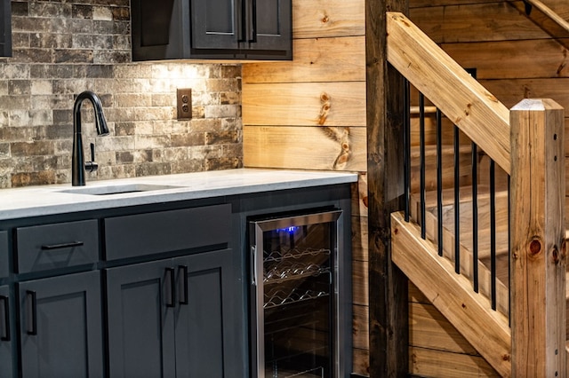 bar with wine cooler, wooden walls, and sink