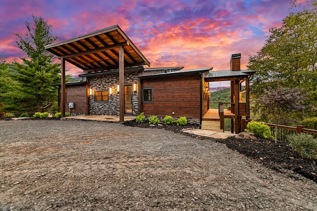 view of back house at dusk