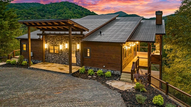 view of back house at dusk