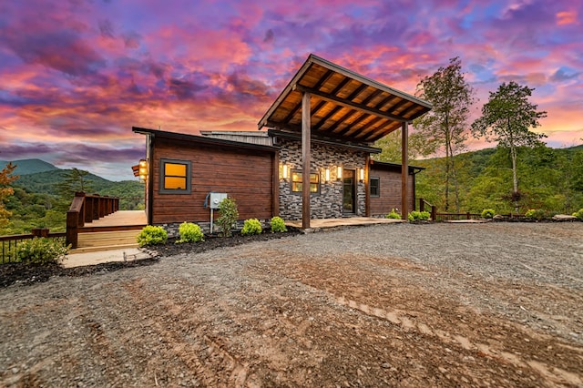 view of front of house featuring a deck with mountain view