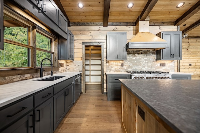 kitchen featuring premium range hood, sink, wooden ceiling, beam ceiling, and light hardwood / wood-style floors