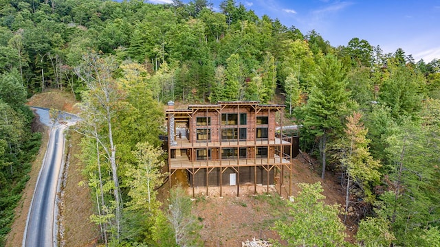 rear view of property featuring a wooden deck