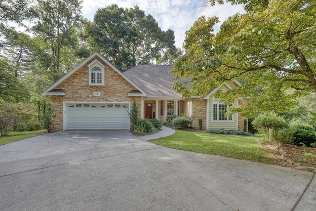 view of front of property with a garage and a front lawn