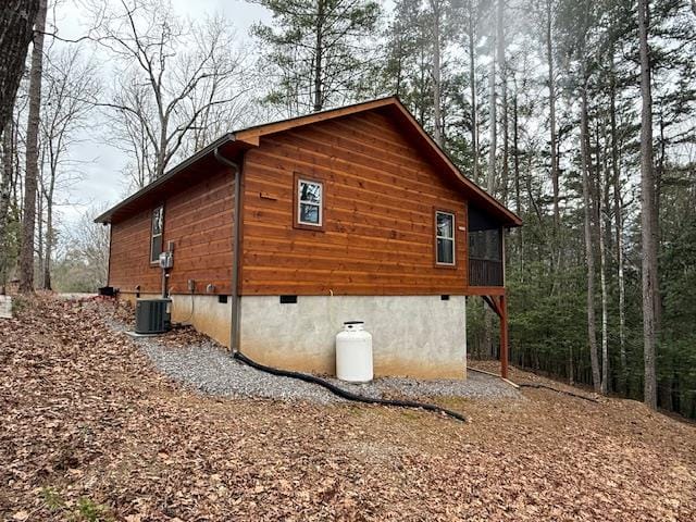 view of side of home featuring central AC unit and crawl space