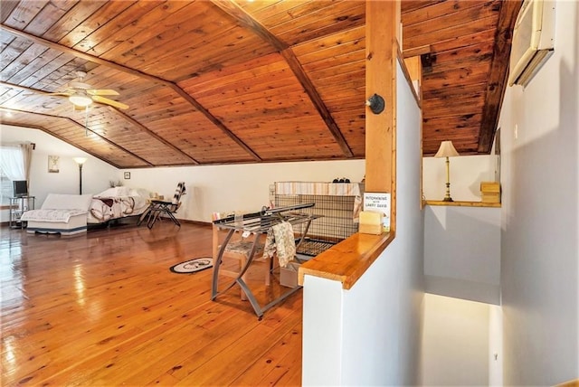 interior space featuring wooden ceiling, a wall unit AC, ceiling fan, hardwood / wood-style floors, and lofted ceiling