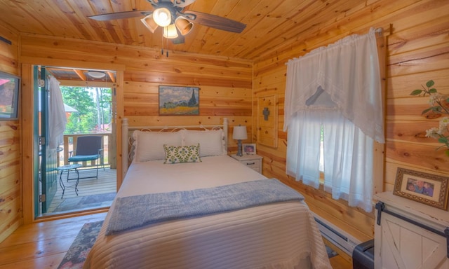 15 June Marie Ln, Murphy, NC 28906 - bedroom with access to exterior, wooden walls, a baseboard radiator, wooden ceiling, and hardwood / wood-style floors