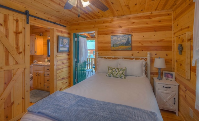 15 June Marie Ln, Murphy, NC 28906 - bedroom featuring wood walls, wood ceiling, a barn door, ensuite bathroom, and light wood-style flooring