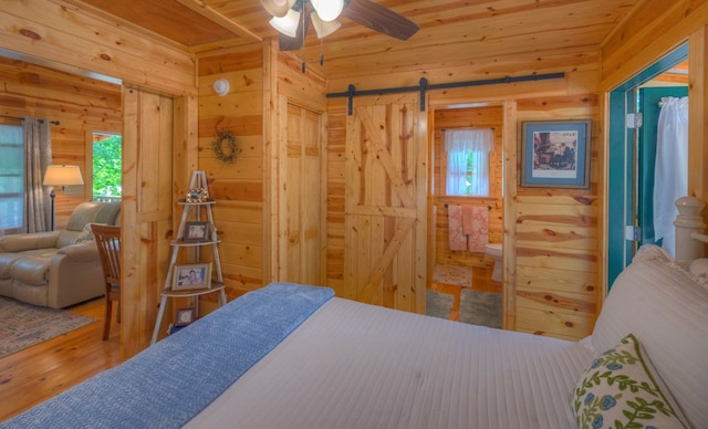15 June Marie Ln, Murphy, NC 28906 - bedroom featuring wood walls, multiple windows, wood finished floors, wood ceiling, and a barn door