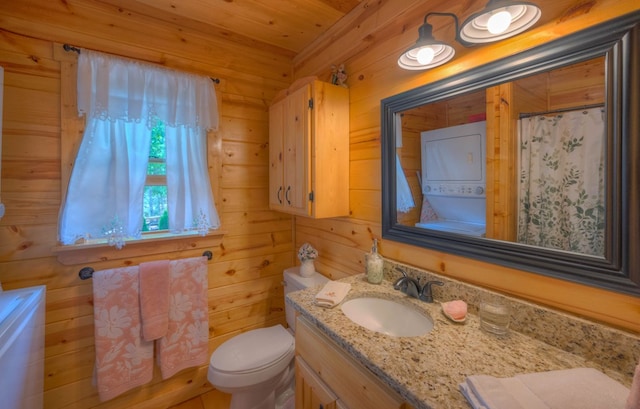 15 June Marie Ln, Murphy, NC 28906 - full bathroom featuring stacked washer and clothes dryer, vanity, toilet, wood walls, and wooden ceiling