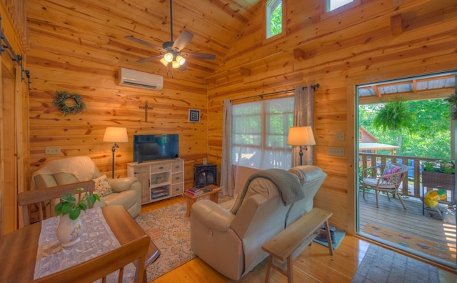 15 June Marie Ln, Murphy, NC 28906 - living room featuring an AC wall unit, plenty of natural light, a wood stove, light wood-type flooring, and high vaulted ceiling