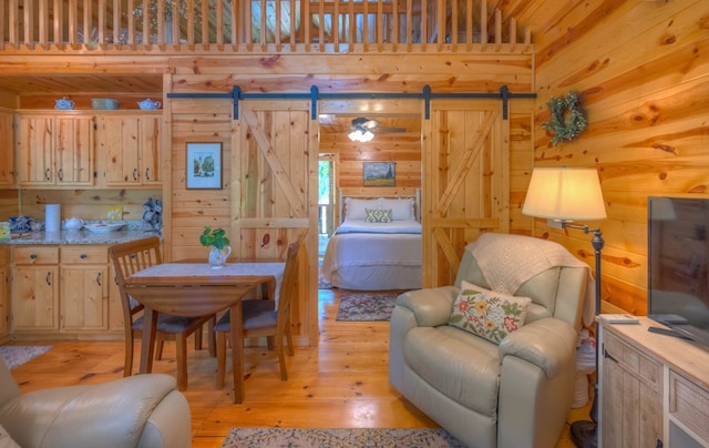 15 June Marie Ln, Murphy, NC 28906 - dining space with a barn door, wood walls, and light wood-style flooring
