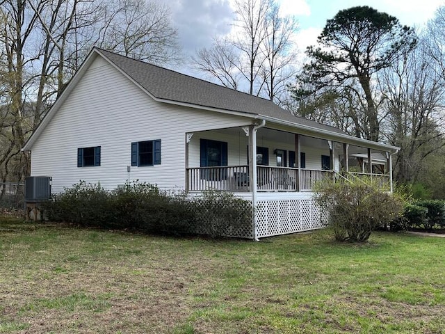 back of house featuring a porch, a yard, and cooling unit