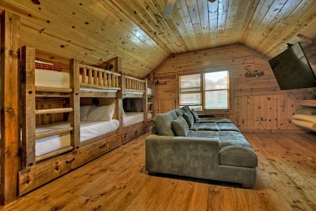 living room featuring wooden ceiling, vaulted ceiling, wooden walls, and light wood-type flooring