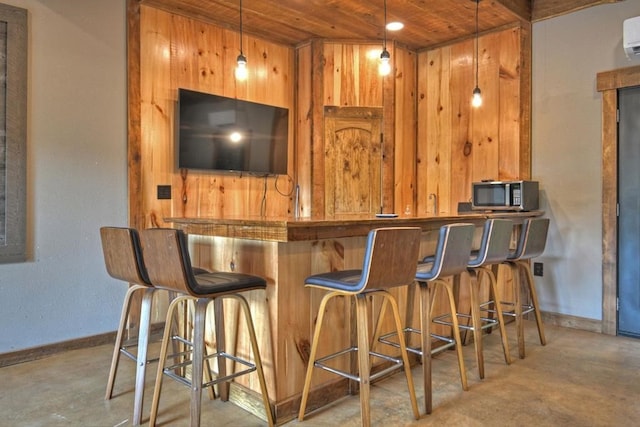 bar featuring wooden walls, wooden ceiling, a wall unit AC, and hanging light fixtures