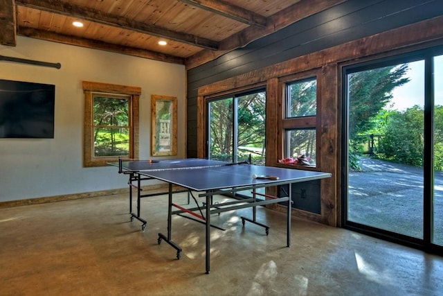 rec room featuring wooden ceiling, concrete flooring, wooden walls, and beamed ceiling