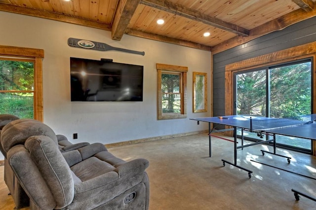 recreation room with concrete flooring, wood ceiling, wood walls, and beamed ceiling