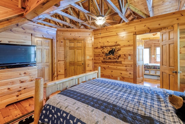 bedroom with beam ceiling, high vaulted ceiling, wood walls, and wood ceiling