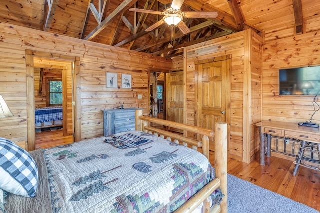 bedroom featuring ceiling fan, lofted ceiling with beams, wooden walls, hardwood / wood-style flooring, and wood ceiling