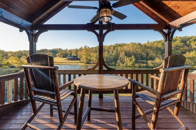 wooden terrace with ceiling fan and a water view