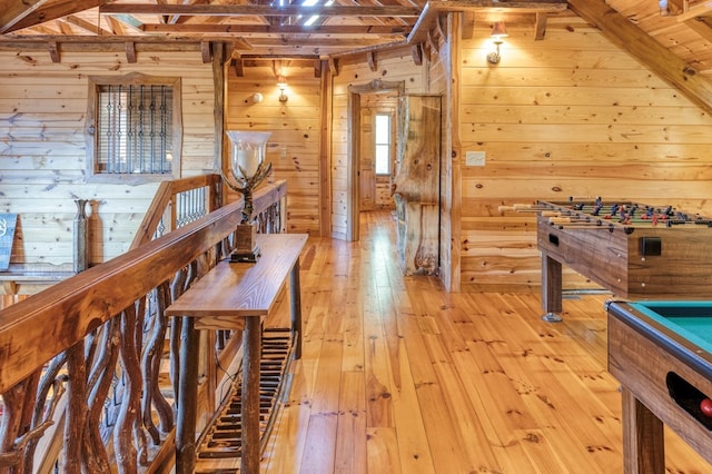 rec room with wood walls, lofted ceiling with beams, light wood-type flooring, wood ceiling, and pool table