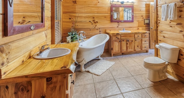 bathroom featuring toilet, tile patterned floors, a bathing tub, and wooden walls