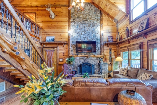 living room with high vaulted ceiling, wooden ceiling, a stone fireplace, and a healthy amount of sunlight