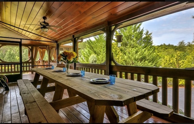 wooden terrace featuring ceiling fan