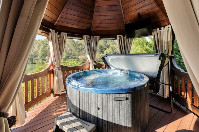 deck with a gazebo and a hot tub