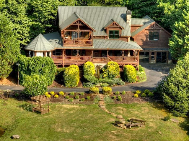 back of house with a garage and a lawn