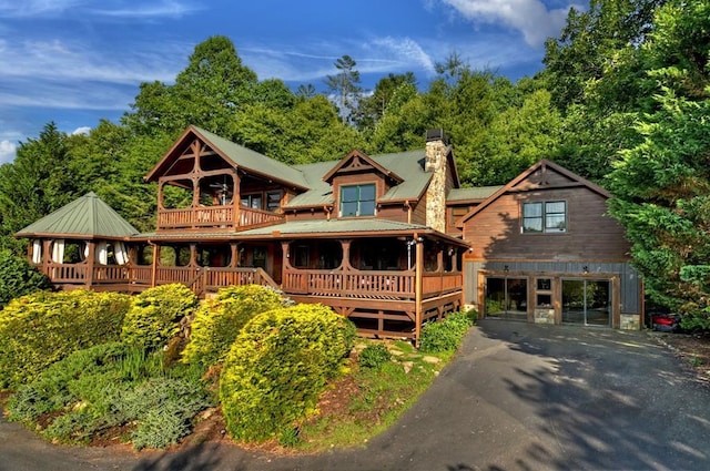 rear view of house with a porch and a balcony