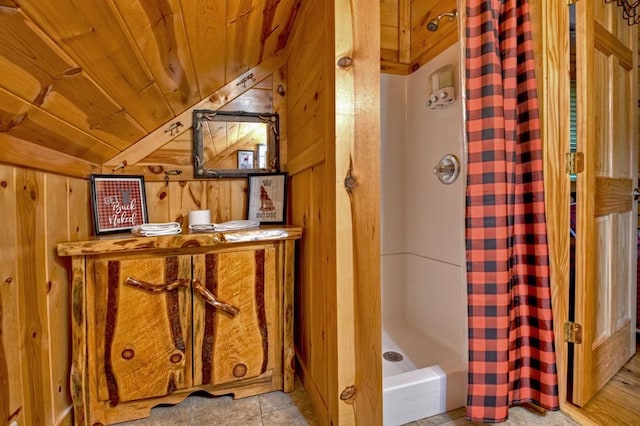 bathroom featuring vaulted ceiling, wood ceiling, a shower with curtain, and wooden walls