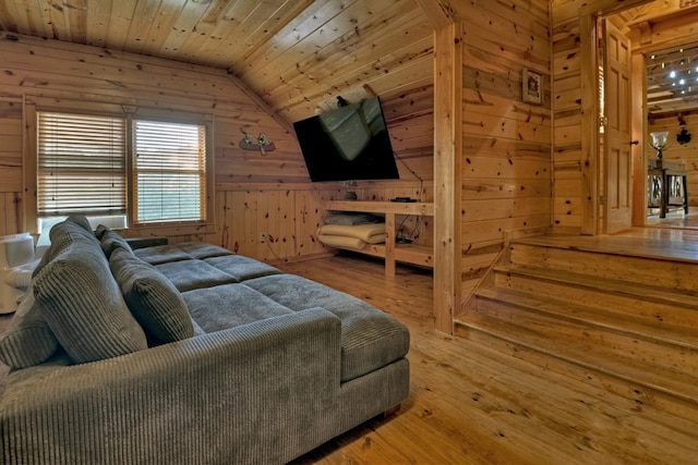 living room featuring lofted ceiling, wood ceiling, wooden walls, and hardwood / wood-style flooring