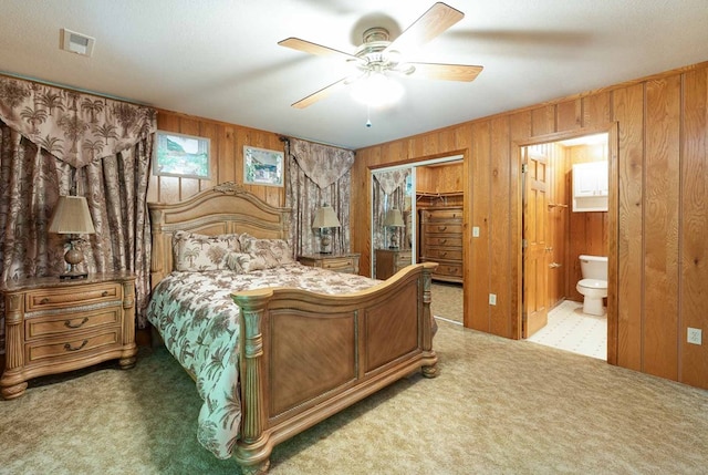 132 Silver Birch Ln, Marble, NC 28905 - bedroom with carpet flooring, wood walls, connected bathroom, a spacious closet, and a closet