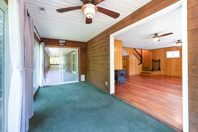 132 Silver Birch Ln, Marble, NC 28905 - unfurnished sunroom featuring ceiling fan and a wood stove