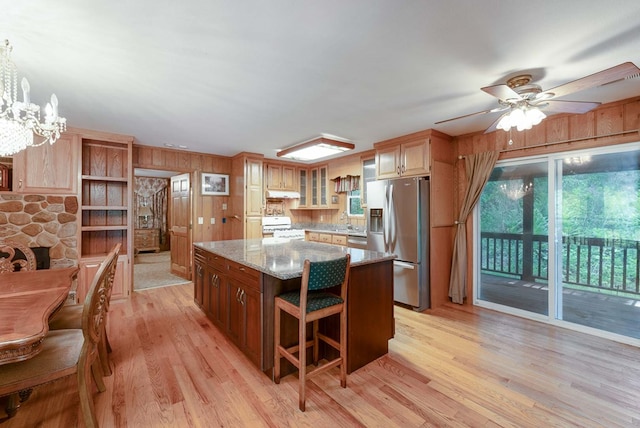 132 Silver Birch Ln, Marble, NC 28905 - kitchen with stainless steel fridge with ice dispenser, gas range gas stove, light wood finished floors, a kitchen island, and light stone counters
