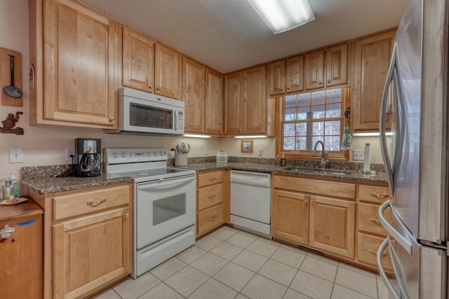 2478 Hi River Rd, Hiawassee, GA 30546 - kitchen featuring a sink, a textured ceiling, dark stone counters, white appliances, and light tile patterned floors