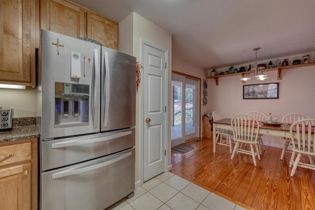 2478 Hi River Rd, Hiawassee, GA 30546 - kitchen with light tile patterned floors, a notable chandelier, stainless steel refrigerator with ice dispenser, and open shelves
