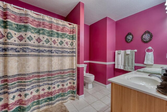2478 Hi River Rd, Hiawassee, GA 30546 - bathroom with vanity, a textured ceiling, curtained shower, tile patterned floors, and toilet