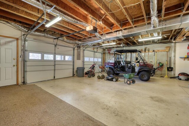 2478 Hi River Rd, Hiawassee, GA 30546 - garage featuring electric panel and a garage door opener
