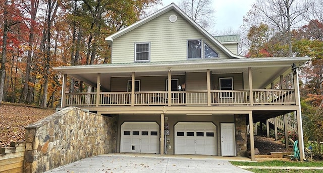 2478 Hi River Rd, Hiawassee, GA 30546 - farmhouse featuring a garage, metal roof, and a porch