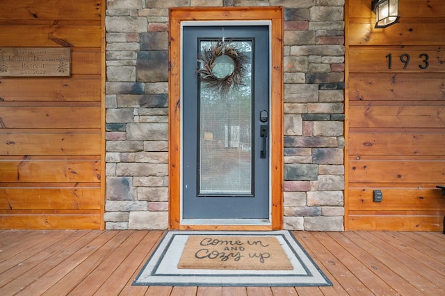 view of exterior entry featuring stone siding